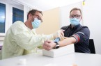 Thorsten Engelking, Mitarbeiter des HDZ NRW (Foto li.), nimmt EDEKA-Mitarbeiter Mario Grotefeld Blut ab für den Antikörpertest.  Foto: 	EDEKA Minden-Hannover
